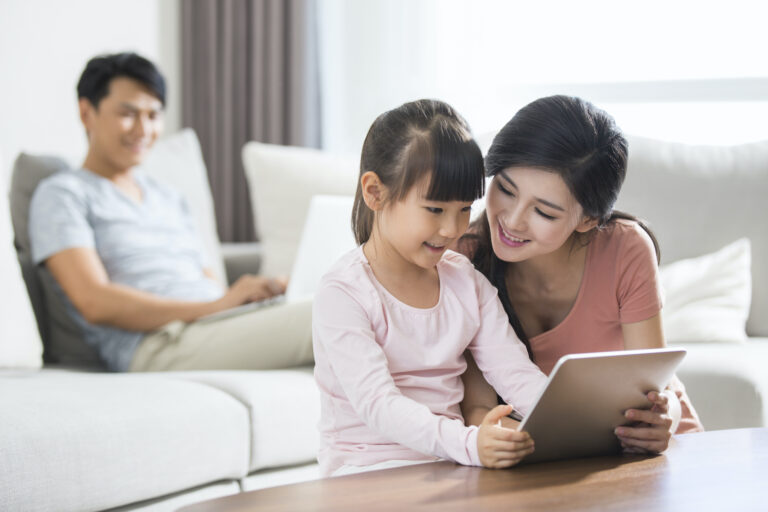 happy-young-family-using-digital-gadgets-at-home