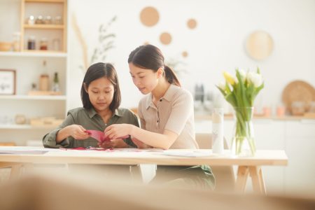 mom helping daughter with homework